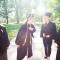 Group of students laughing, wearing caps and gowns