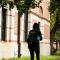 Several students walking down sidewalk on campus