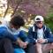 Two men praying together on the steps outside of campus building