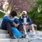 Two students praying for each other outside on stone steps