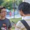 Stephan on campus talking with two students outside