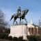 Statue of Robert E. Lee on horse on pedestal in park