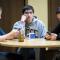 Three students sitting at a table. Two are focused on texting while another is looking bored and left out.