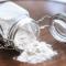 a flour jar tipped over on a table and spilling out