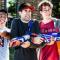 Three young male students posing with Nerf guns