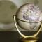 Globe sitting on counter with its shadow spreading across the wall