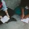 Two women seated on floor studying Scripture