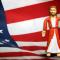 Jesus action figure standing in front of American flag backdrop