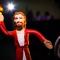 Jesus action figure standing in spotlight with dark background