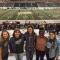 Kerrington standing with group of friends at football game