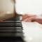 Closeup of person's hands on piano keys