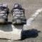 Pair of running shoes sitting on top of rock on the pavement