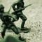 An image of toy soldiers in sand