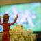 Jesus action figure in front of popcorn bowl facing TV