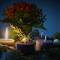 Four candles in a wreath surrounding a spring of poinsettia