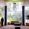 man standing left of center in empty student union