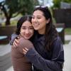 two women hugging on campus