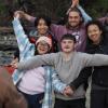 diverse group photo of people making a star shape with their arms and hands linked