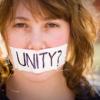 Closeup of woman with paper over mouth with the word: Unity?