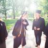 Group of students laughing, wearing caps and gowns