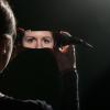 a woman's eyes reflected in a shard of glass