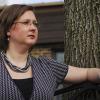 Woman sitting on bench outside looking thoughtful