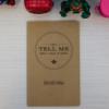 a small canvas notebook with "Just Tell Me What I Need to Know" on its cover