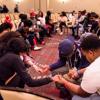 Group of Black students praying in circle holding hands