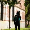 Several students walking down sidewalk on campus