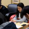 Group of Asian American students praying during Bible study