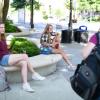 Two female students listening to another female student share the gospel