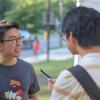 Stephan on campus talking with two students outside