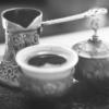 Black and white image of ornate coffee pot and cups