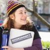 Female college student outside carrying school books