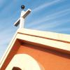Closeup of church steeple rising up into blue sky