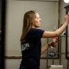 Woman cleaning bathroom mirror