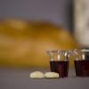 Two small communion cups and two pieces of bread