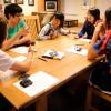 a group of students talking around a table