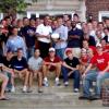 Group photo of male college students outside fraternity house