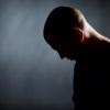 side view of a man with his head facing down