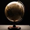 a globe sitting on a table in a dimly lit room