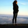 Woman standing on ridge overlooking mountains