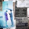 Clippings of newspapers beside Blue Like Jazz Movie Poster of young man holding umbrella for young woman