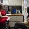 Two women having conversation in office cubicle