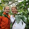 a couple smiling together in a wooded area