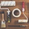 Set of tools on table including paint rollers and brushes