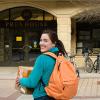 Student and mother walking with boxes toward campus building