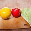 a wooden table with fruits, vegetables, and knife
