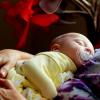 Baby resting in mother's arms