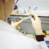 Medical researcher examining test tubes